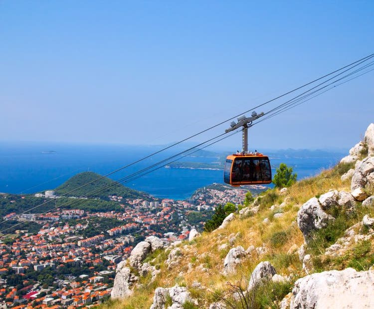 A cable car traveling over the walled city of Dubrovnik, Croatia