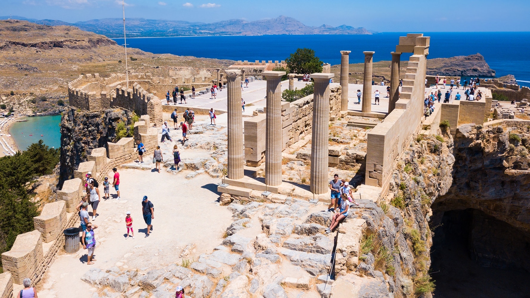 Tourists exploring the ancient acropolis of Lindos in Rhodes Greece a cultural highlight on Greek island cruise excursions