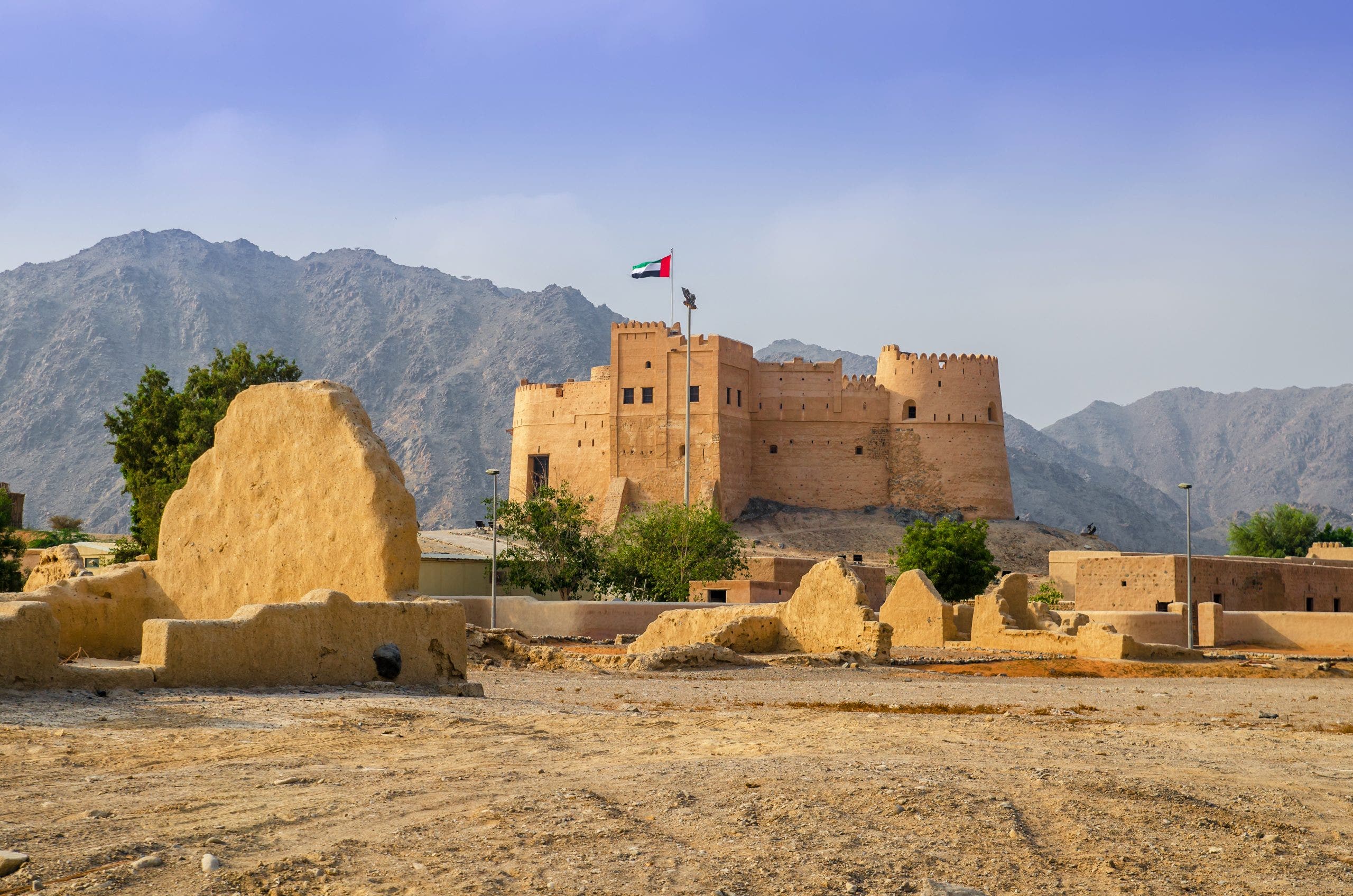 Historic fort in Fujairah United Arab Emirates with mountain backdrop a cultural site featured on Arabian Gulf cruise excursions