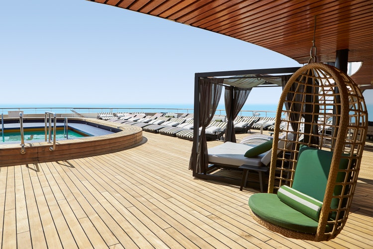 The Celestyal Journey terrace, showing sunloungers and a swimming pool