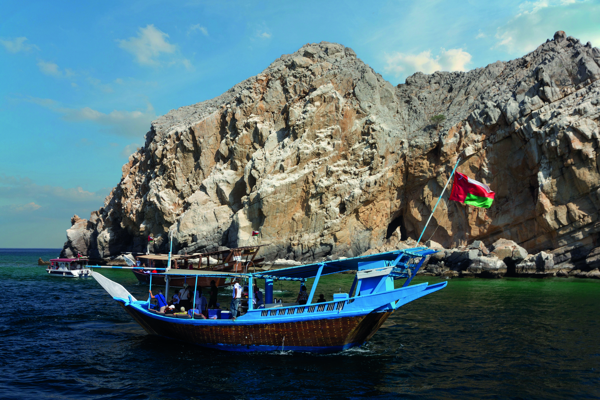 Sailing tourist dhow boat in Oman mountain fjords, Khasab.